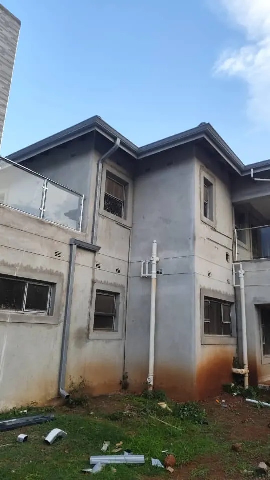 Charcoal gutters and downpipes on a double-storey house