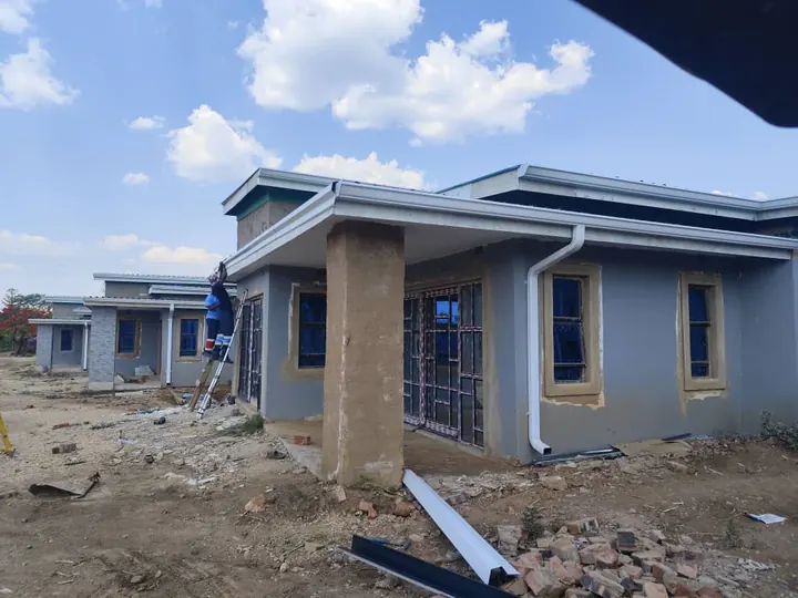 Our team fitting white gutters to a new development