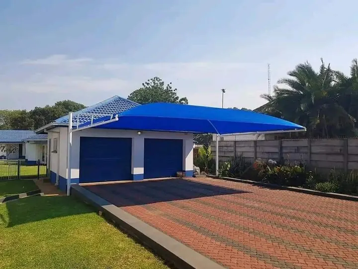Blue cantilever shade over a double-garage driveway