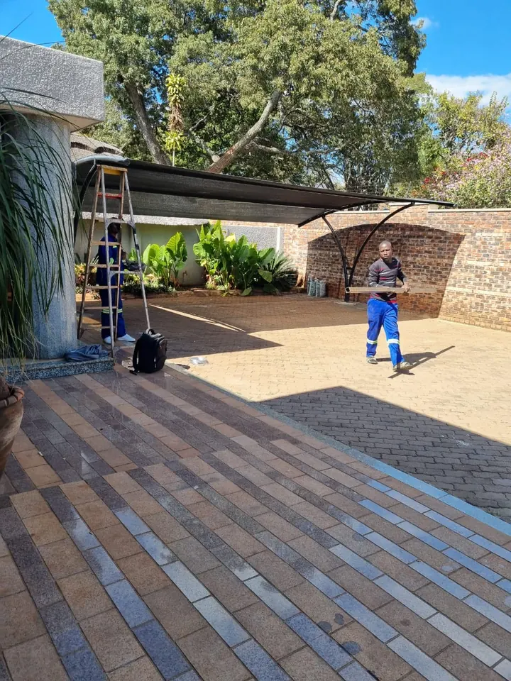 Charcoal curved shade over a paved courtyard