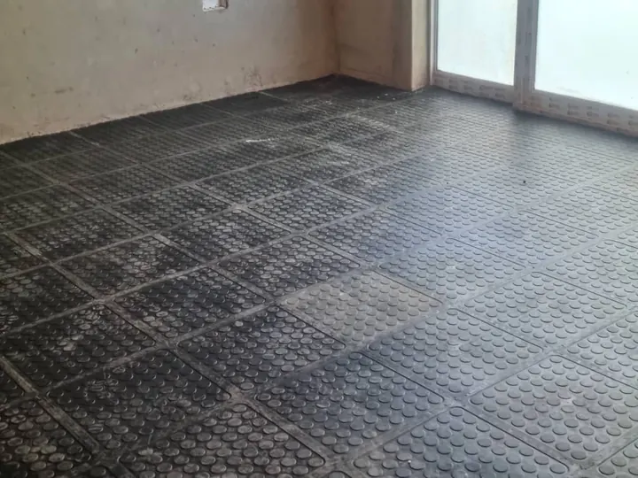 A full room floored with interlocking coin-top tiles